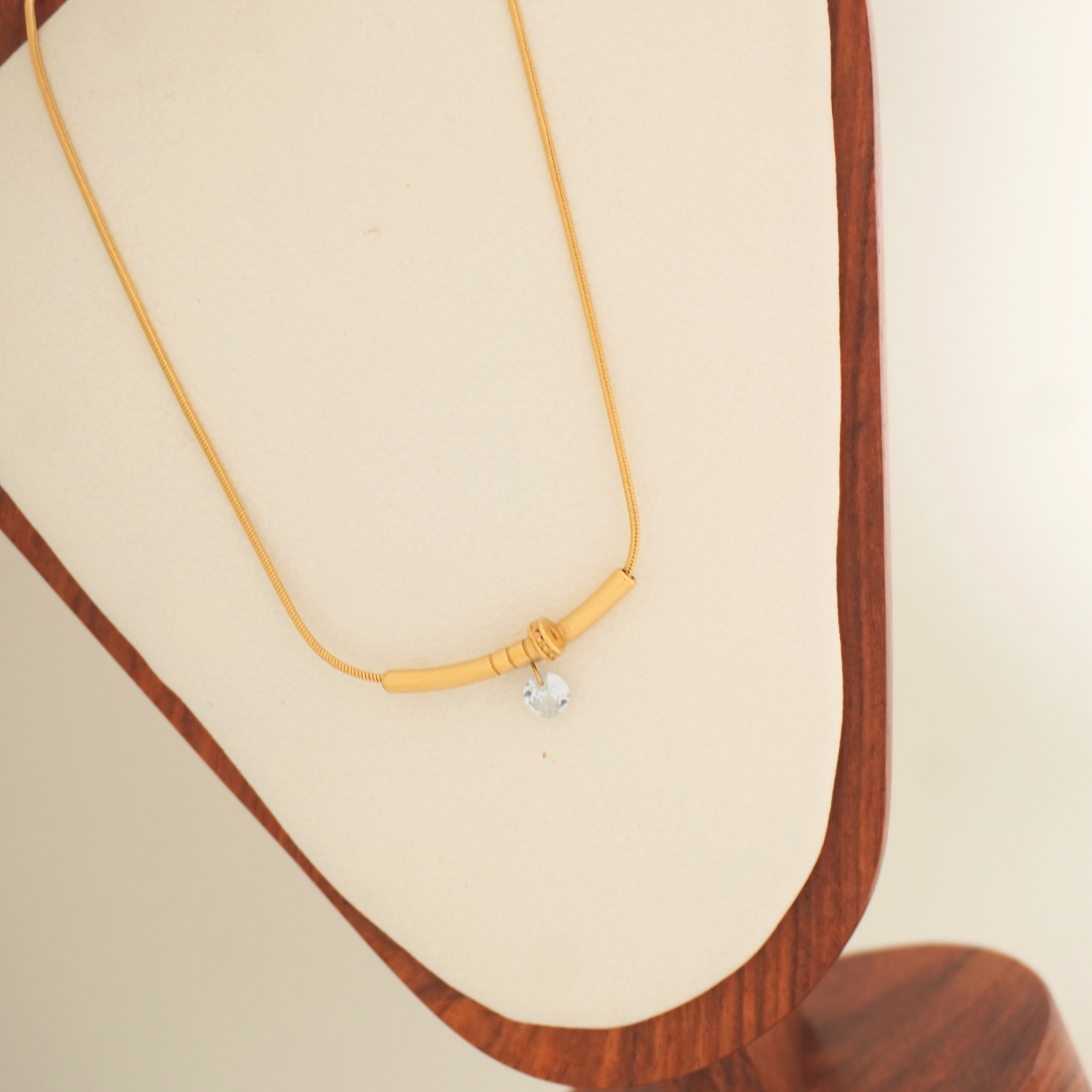 Minimal gold necklace with knot detail and silver charm – Ashara Serene Knot Necklace